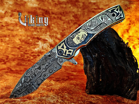 Handmade Damascus Folding Knife with Ivar the Boneless Carving Handle. Viking_Blade_Crafts