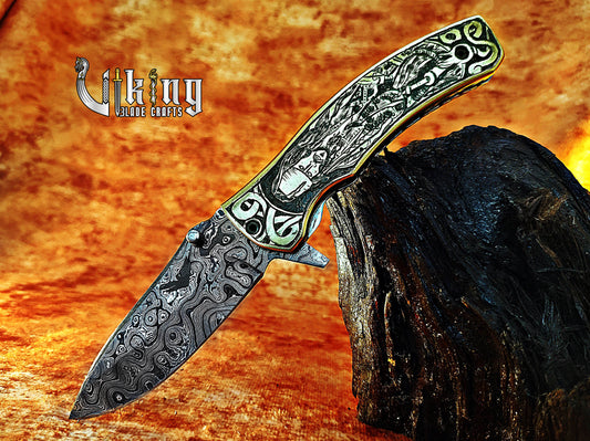Damascus steel folding knife with Pirates of the Caribbean carved handle