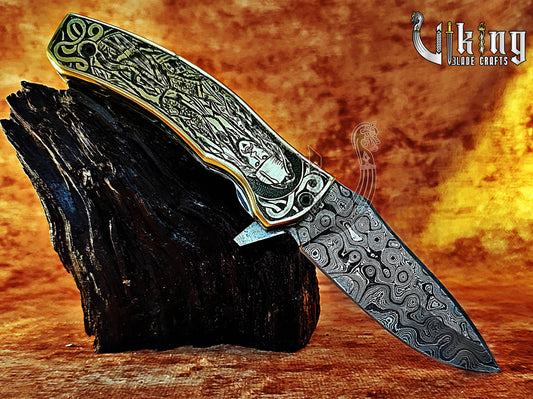 Damascus steel folding knife with Pirates of the Caribbean carved handle