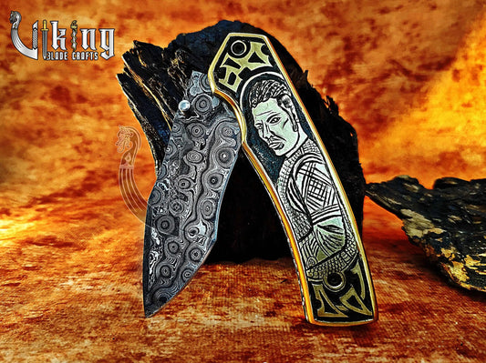 Handmade Damascus Folding Knife with Ivar the Boneless Carving Handle. Viking_Blade_Crafts
