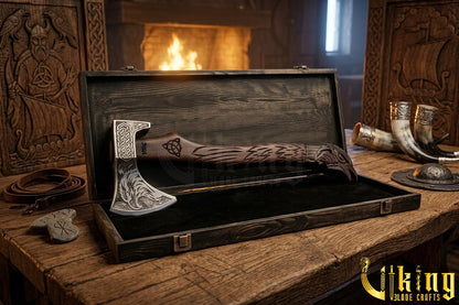 forged steel Viking axe with detailed raven carving and rosewood handle