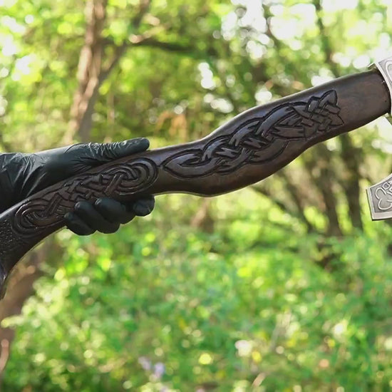 Viking battle axe with hand carved wolf handle and forged steel blade
