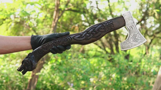 Viking battle axe with hand carved wolf handle and forged steel blade